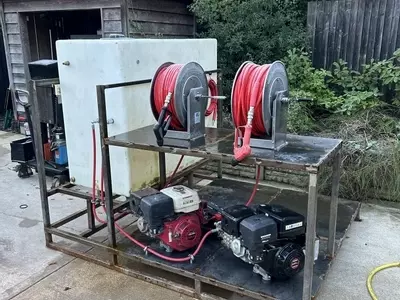 Custom fabricated frame with twin diesel pressure washers and dual hose reels built for a van-mounted off-grid cleaning system in Birmingham.